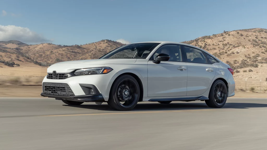 White car driving on rural road.
