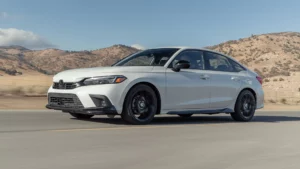 White car driving on rural road.